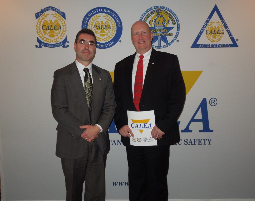 Claremont, NH Police Chief Alex Scott and NNEPAC Secretary and Claremont PD's Accreditation Manager Bill Wilmot pose for a photo after receiving their reaccreditation award at the Miamii CALEA conference.